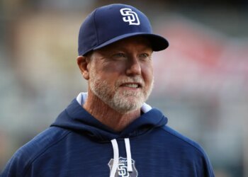 Mark McGwire smiles before an exhibition baseball game.