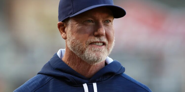 Mark McGwire smiles before an exhibition baseball game.