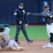 Mets shortstop Francisco Lindor, right, throws to first base after a force out against Athletics' Max Muncy (3) at second base during the fifth inning of a baseball game, Saturday, April 11, 2026.