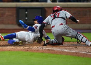 Francisco Lindor slides safely into home on Francisco Alvarez's double in the fourth inning on April 22, 2026 at Citi Field but had to later leave the game with left calf tightness.