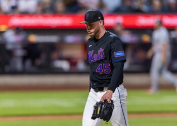 New York Mets pitcher Christian Scott walking off the field after being pulled from the game against the Minnesota Twins.