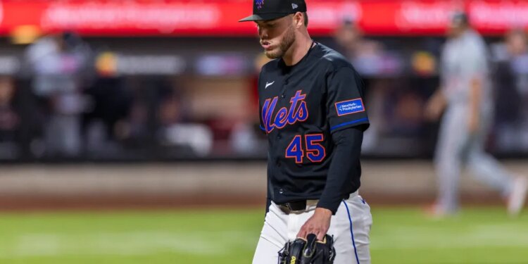 New York Mets pitcher Christian Scott walking off the field after being pulled from the game against the Minnesota Twins.