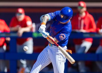 New York Mets’ A.J. Ewing hits a baseball during spring training.