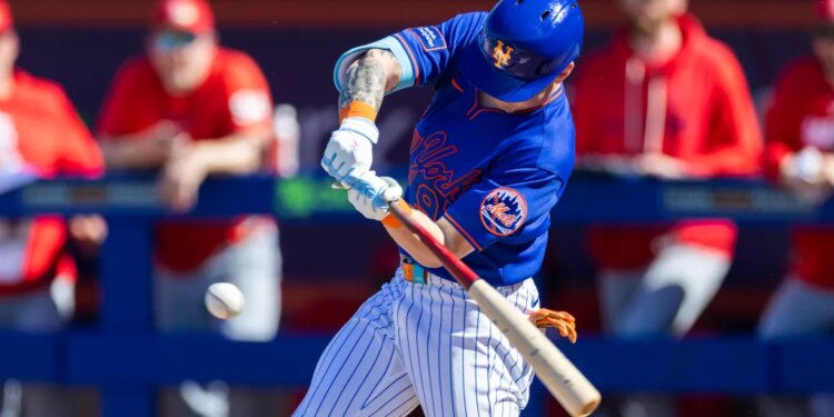 New York Mets’ A.J. Ewing hits a baseball during spring training.