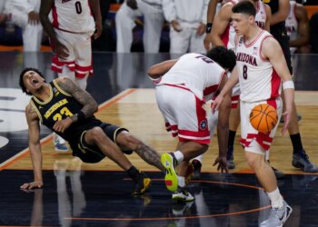 Michigan forward Yaxel Lendeborg falls on the court during a basketball game against Arizona.