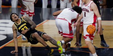 Michigan forward Yaxel Lendeborg falls on the court during a basketball game against Arizona.
