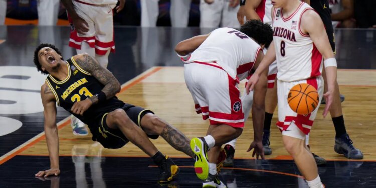 Michigan forward Yaxel Lendeborg falls on the court during a basketball game against Arizona.