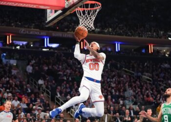 Knicks guard Jordan Clarkson (0) sores a layup against the Boston Celtics during the first half at Madison Square Garden.