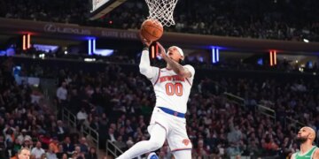 Knicks guard Jordan Clarkson (0) sores a layup against the Boston Celtics during the first half at Madison Square Garden.