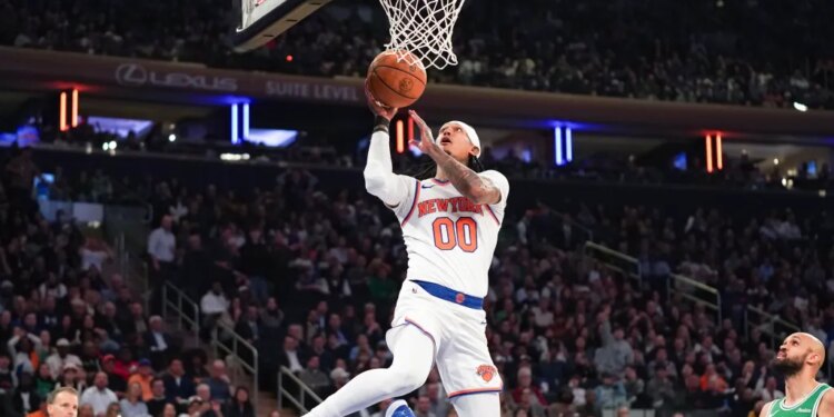 Knicks guard Jordan Clarkson (0) sores a layup against the Boston Celtics during the first half at Madison Square Garden.
