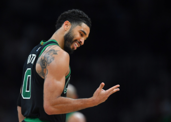 Jayson Tatum smiling in his Boston Celtics jersey.