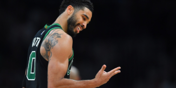 Jayson Tatum smiling in his Boston Celtics jersey.