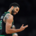 Jayson Tatum smiling in his Boston Celtics jersey.