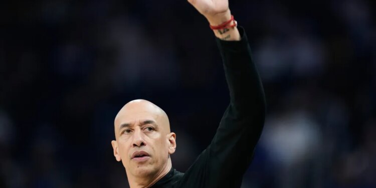 Sacramento Kings head coach Doug Christie gestures during a game.