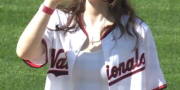 Nationals fan Sorcha Lewis celebrates her 21st birthday with a ceremonial "first sip" of beer on the mound on April 4, 2026.
