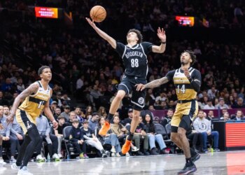 Nets guard Nolan Traore (88) shoots past Washington Wizards Leaky Black during the first half at Barclays Center, Sunday, April 5, 2026, in Brooklyn, NY.