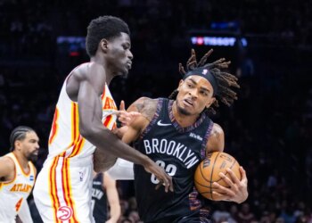 Nets center Nic Claxton (33) drives against Atlanta Hawks forward Mouhamed Gueye (18) during the first half at Barclays Center, Friday, April 3, 2026, in Brooklyn, NY.