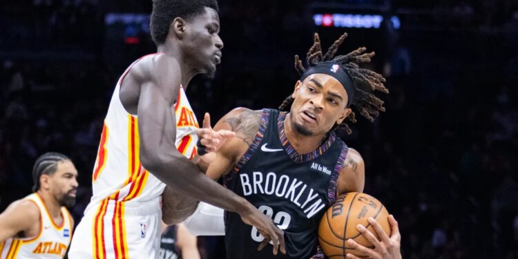 Nets center Nic Claxton (33) drives against Atlanta Hawks forward Mouhamed Gueye (18) during the first half at Barclays Center, Friday, April 3, 2026, in Brooklyn, NY.