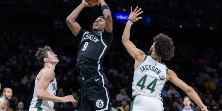 E.J. Liddell, who scored a game-high 21 points, shoots over AJ Green (20) and Andre Jackson Jr. (44) during the Nets' 96-90 win over the Bucks on April 7, 2026 at Barclays Center.
