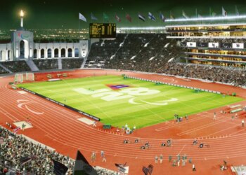 Illustration of a stadium at night, with the LA 2028 and Paralympic logos on the field and track.