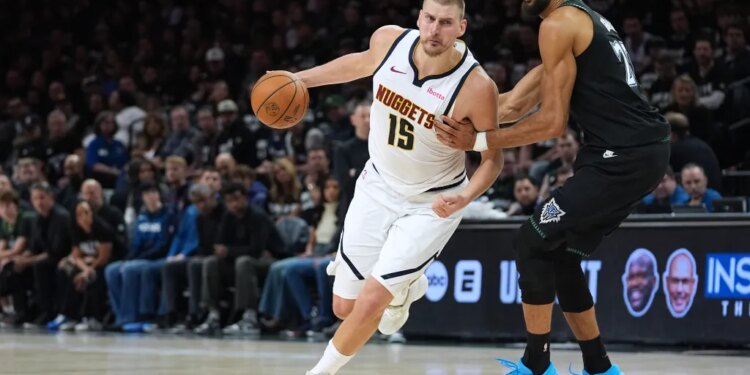 Nikola Jokic works toward the basket while Rudy Gobert defends him in an NBA playoff game.