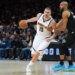 Nikola Jokic works toward the basket while Rudy Gobert defends him in an NBA playoff game.