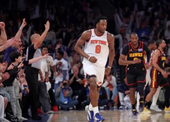 New York Knicks player Og Anunoby #8 reacts after a three-point shot in a game against the Atlanta Hawks at Madison Square Garden.