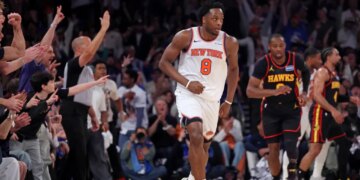 New York Knicks player Og Anunoby #8 reacts after a three-point shot in a game against the Atlanta Hawks at Madison Square Garden.