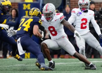 Ohio State Buckeyes linebacker Arvell Reese (8) tackling Michigan Wolverines running back Bryson Kuzdzal (24).
