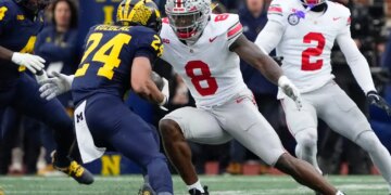 Ohio State Buckeyes linebacker Arvell Reese (8) tackling Michigan Wolverines running back Bryson Kuzdzal (24).