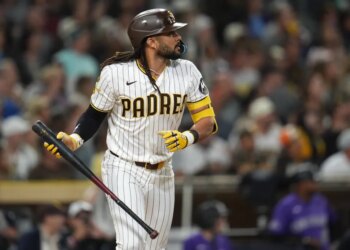 Fernando Tatis Jr. of the San Diego Padres watches his sacrifice fly.