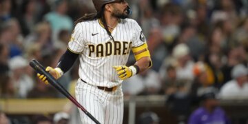 Fernando Tatis Jr. of the San Diego Padres watches his sacrifice fly.