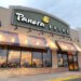 Exterior of a Panera Bread restaurant with its sign and awnings, next to a Carter's store.