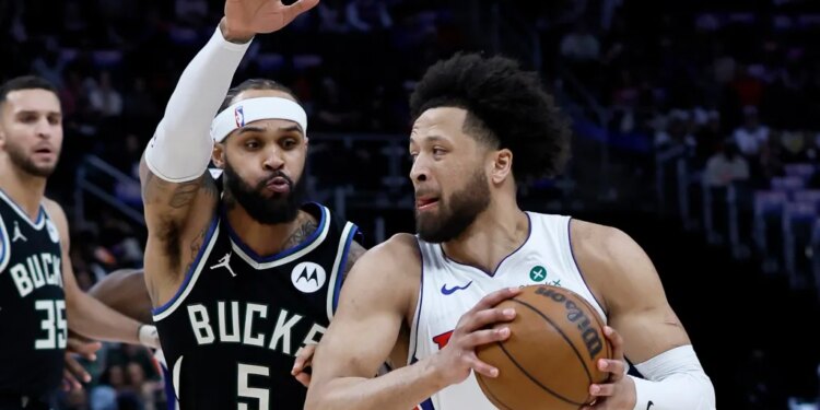 Returning star guard Cade Cunningham drives on Milwaukee's Gary Trent Jr. during the Piston-Bucks game on April 8, 2026 in Detroit.