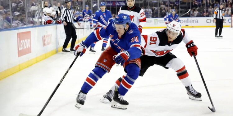 Dawson Mercer #91 of the New Jersey Devils checks left wing Adam Sykora #38 of the New York Rangers during the first period at Madison Square Garden, Tuesday, March 31, 2026, in New York, NY.