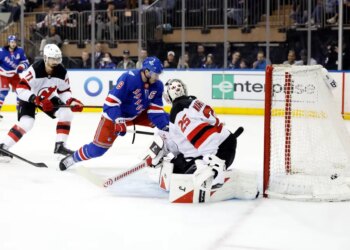 New York Rangers player J.T. Miller #8 scores a goal past New Jersey Devils goaltender Jacob Markstrom #25.