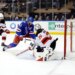 New York Rangers player J.T. Miller #8 scores a goal past New Jersey Devils goaltender Jacob Markstrom #25.