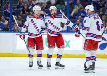 Mika Zibanejad (center) celebrates with Alexis Lafrenière (left) and J.T. Miller after scoring a second-period goal during the Rangers' 4-2 win over the Lightning on April 15, 2026 at Benchmark International Arena.