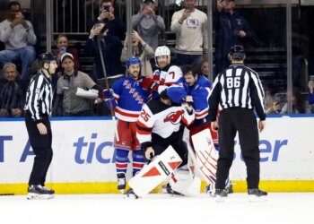 New York Rangers Igor Shesterkin and New Jersey Devils Jacob Markstrom in a scuffle on the ice.