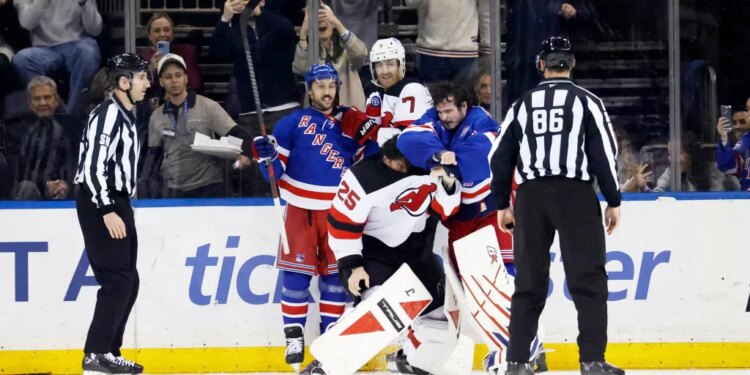 New York Rangers Igor Shesterkin and New Jersey Devils Jacob Markstrom in a scuffle on the ice.