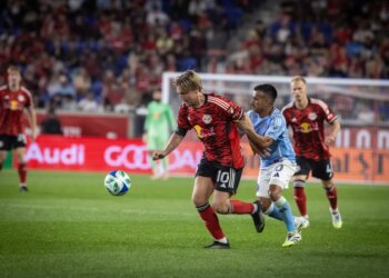 NYCFC midfielder Maxi Moralez grabbing RBNY midfielder Emil Forsberg during a soccer match.