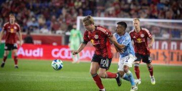 NYCFC midfielder Maxi Moralez grabbing RBNY midfielder Emil Forsberg during a soccer match.