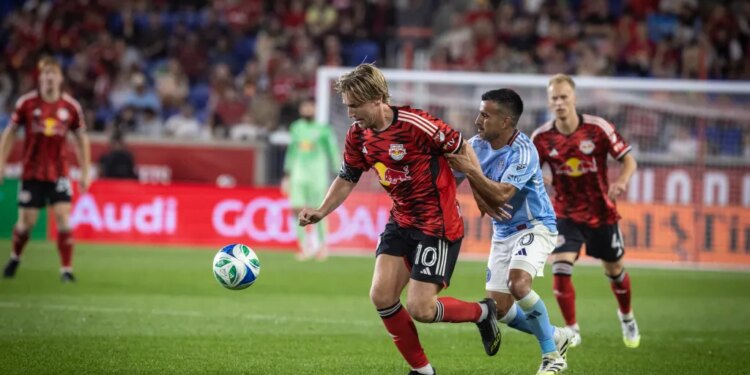 NYCFC midfielder Maxi Moralez grabbing RBNY midfielder Emil Forsberg during a soccer match.