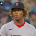 A baseball player, Brayan Bello, standing on the field. Boston 1, Toronto 3.