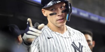 New York Yankees right fielder Aaron Judge #99 reacts in the dugout after he scores on his solo home run during the 6th inning.
