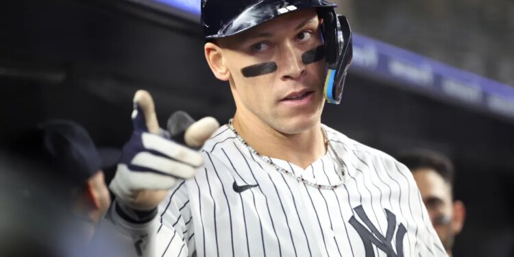 New York Yankees right fielder Aaron Judge #99 reacts in the dugout after he scores on his solo home run during the 6th inning.