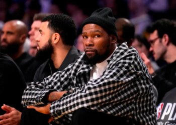 Kevin Durant watching from the sidelines.