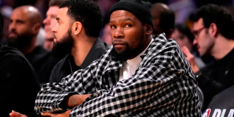 Kevin Durant watching from the sidelines.