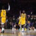 LeBron James (23) of the Los Angeles Lakers celebrates after a play with another Lakers player (5), as other Lakers players and fans cheer.