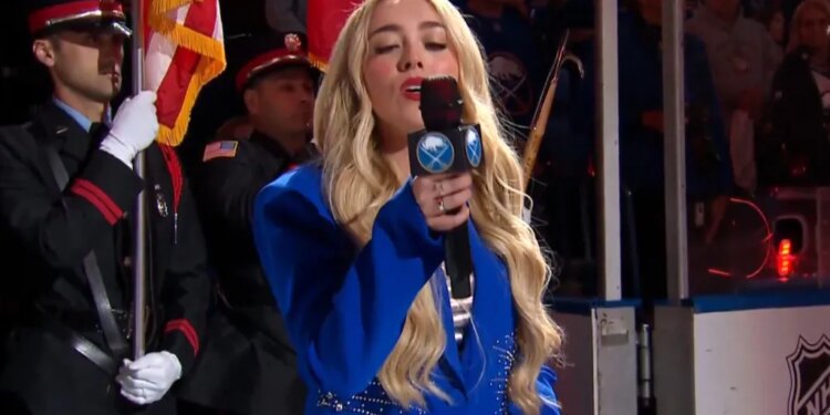 Sabres anthem singer Cami Clune looks at the microphone as it cuts out during "O Canada" on April 28, 2026.